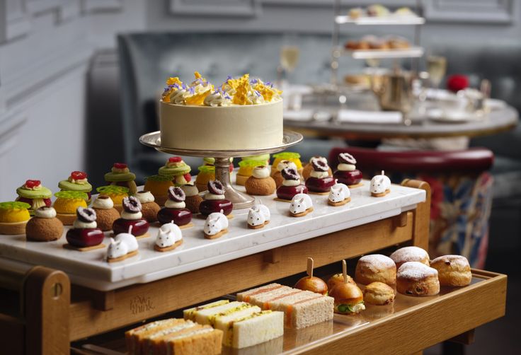 a table topped with lots of different types of cakes and pastries on top of it