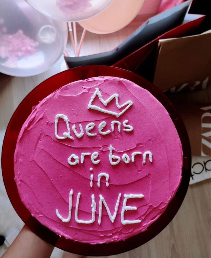 a pink cake with the words queens are born in june on it