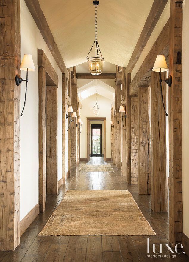 the hallway is lined with wooden pillars and light fixtures, along with two lamps on either side