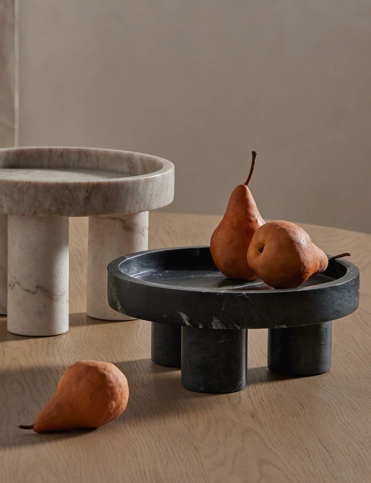 two pears are sitting on top of a table