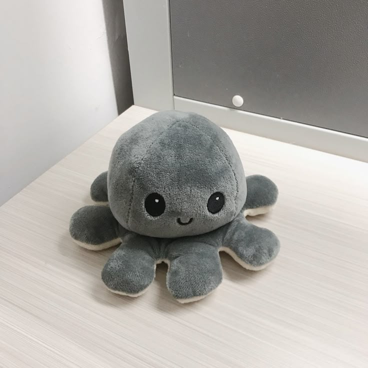 an octopus stuffed animal sitting on top of a table