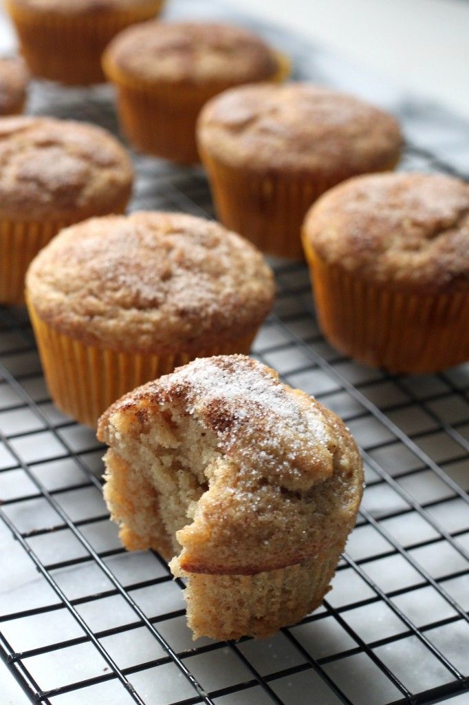 muffins cooling on a wire rack with powdered sugar