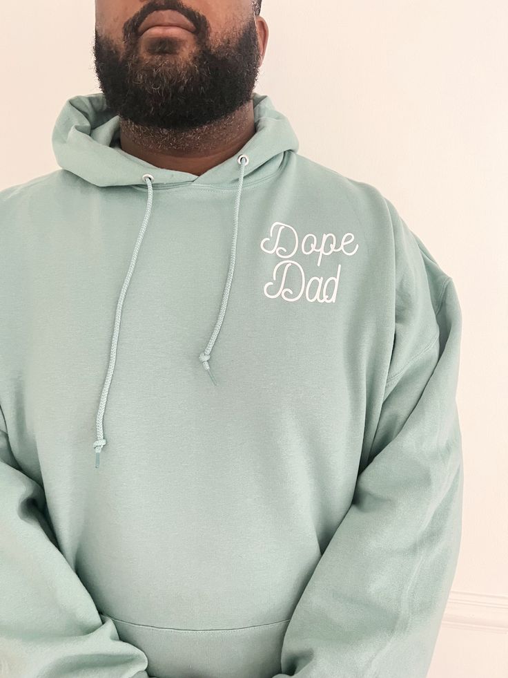 Screen Printed Dope Dad Design Pocket Style made with a cozy 50/50 cotton/polyester blend. Featuring a comfortable hood with a matching drawcord and a convenient pouch pocket, this hoodie is perfect for anyone with its versatile unisex sizing. Choose a range of trendy colors including ocean blue, pecan, coral, heather grey, and classic black, all adorned with white ink color. Soft and cute to wear oversized must-have hoodie. Size and Fit: Choose normal size for relaxed fit. Trendy Hoodie Designs, Mens Hoodie, Mens Sweatshirts Hoodie, Trendy Colors, White Ink, Ocean Blue, Hoodie Design, Ink Color, Small Designs