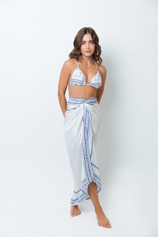 Indulge in luxury with our Capri Sarong, featuring a stunning white and blue print inspired by the idyllic island. Wrap yourself in elegance and style with this must-have fashion accessory, perfect for any beach or poolside occasion. White Sarong For Summer Beach Cover-up, White Triangle Top Swimwear For Vacation, Elegant Swimwear For Vacation And Beach Season, Elegant Swimwear For Vacation Beach Season, Elegant Swimwear For Beach Vacation, Elegant Triangle Top Swimwear For Vacation, Elegant Swimwear For Beach Party Vacation, Elegant Spring Vacation Swimwear, Beachy White Sarong For Beach Cover-up