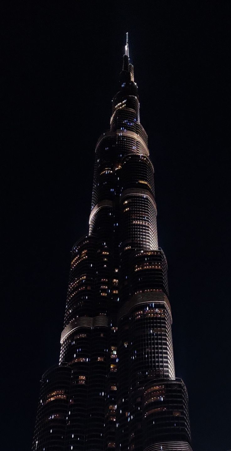 the burj building is lit up at night