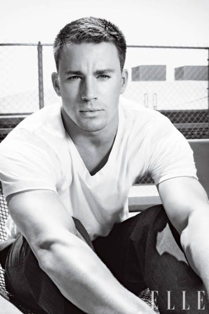 a black and white photo of a man sitting on a bench with his arms crossed