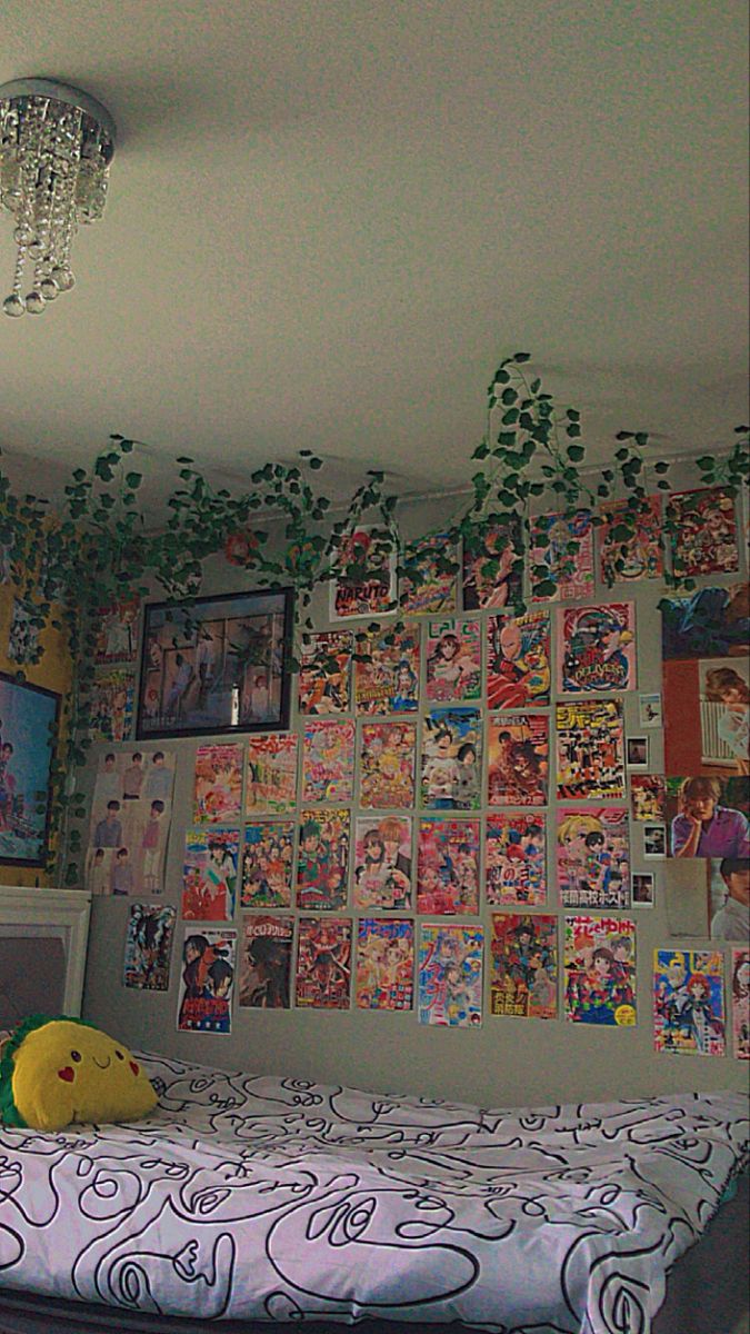 a bedroom with posters on the wall and a child's bed in front of it