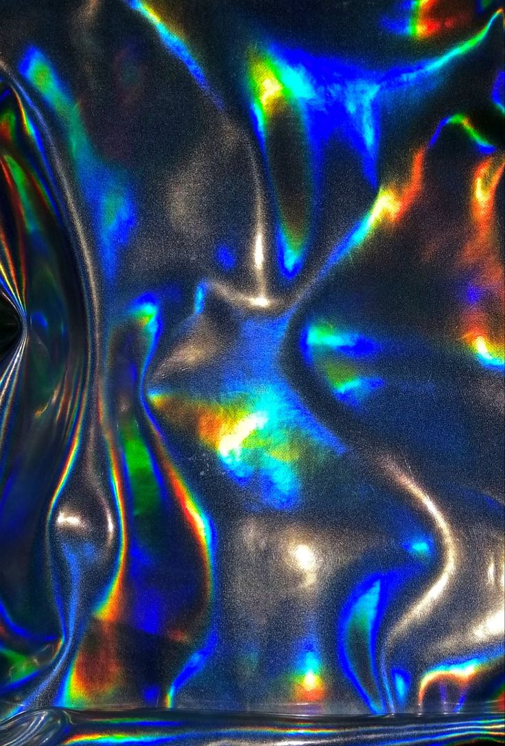 an abstract image of shiny material in blue, green, yellow and orange colors with black background