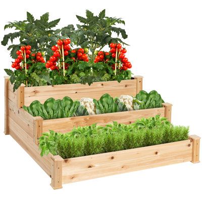 three wooden planters filled with green plants and red berries on top of each other