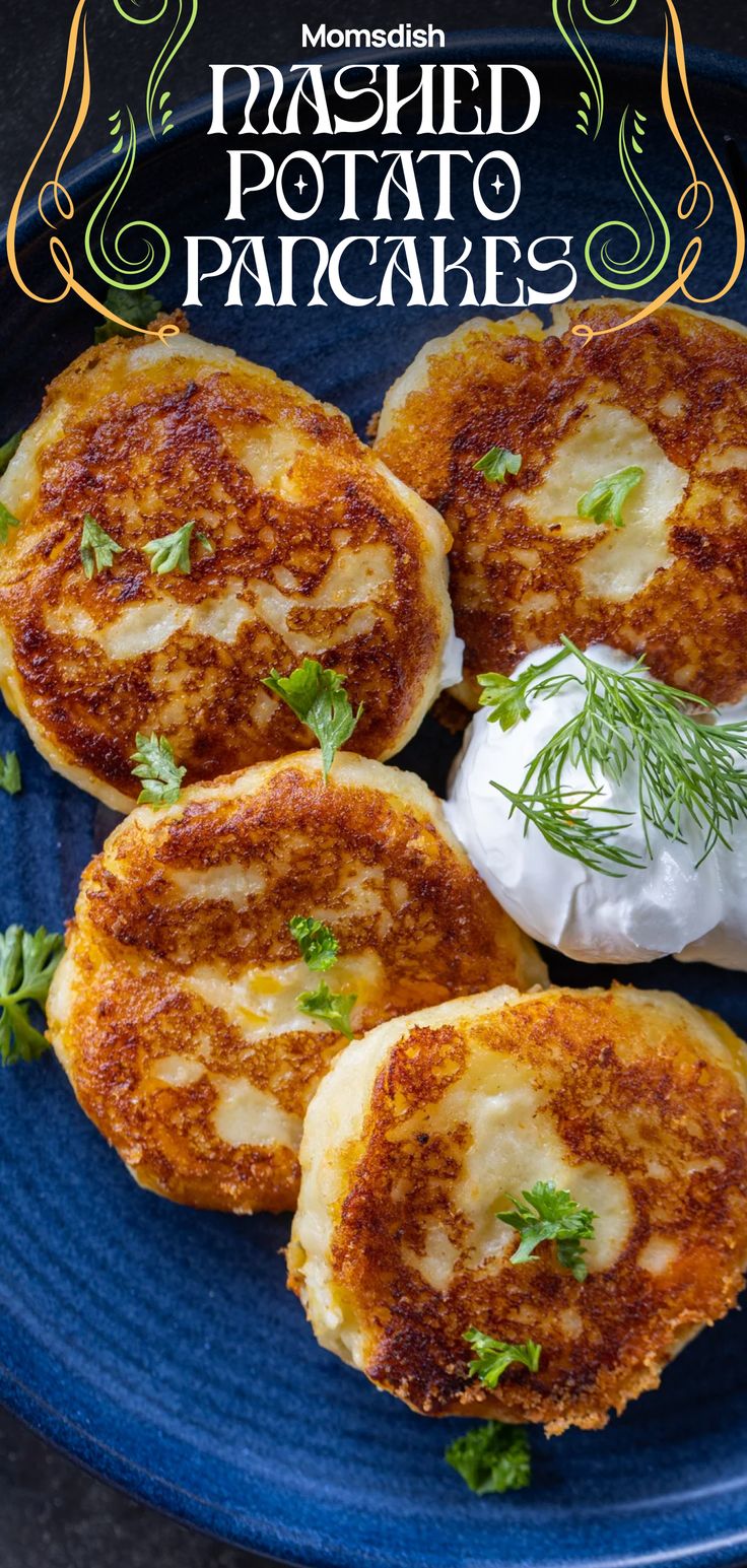 three baked potato pancakes on a blue plate with sour cream and parsley garnish