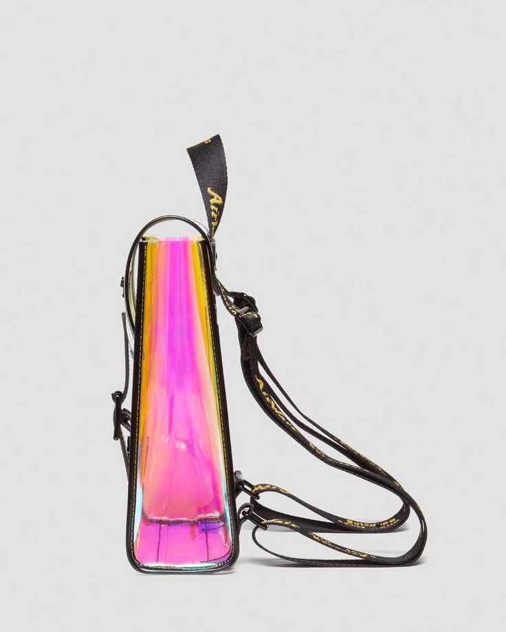 The Dr. Martens Iridescent Transparent Backpack is a mini backpack constructed from transparent iridescent PU. The backpack features branded black hardware and AirWair straps. The material is tough and has a distinctive sheen. The backpack measures Length: 7”, Height: 10”, Depth: 5”. Transparent Backpack, Black Hardware, Mini Backpack, Black Backpack, Dr. Martens, Backpacks, Luxury Fashion, Quick Saves, Black