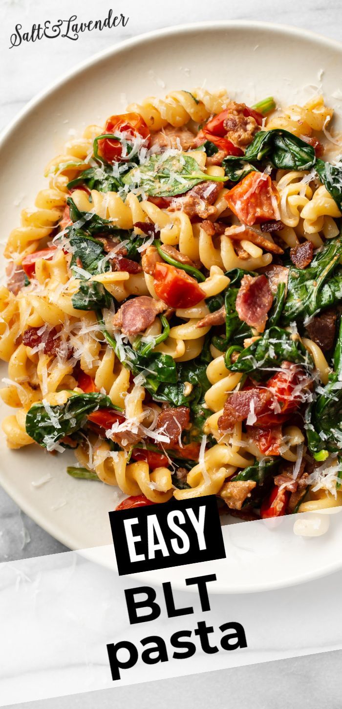 a white plate topped with pasta and spinach