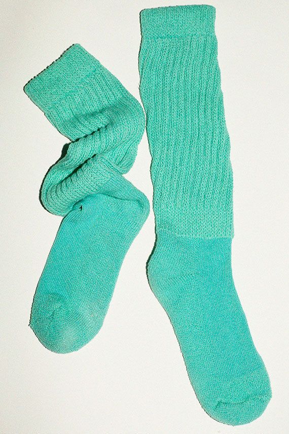 Slouchy knee high socks in a cotton/nylon blend. Thick ribbed cuff and a slim, fitted foot. Made in the USA. Available in multiple colors. Green Casual Knee-high Socks For Stocking Stuffer, Fitted Solid Color Knee-high Socks, Spring Casual Mid-calf Stockings, Casual Mid-calf Stockings For Spring, Cotton Stretch Solid Color Hosiery, Stretch Cotton Solid Color Hosiery, Fitted Mid-calf Solid Color Socks, Spring Cotton Stretch Hosiery, Stretch Mid-calf Winter Stockings