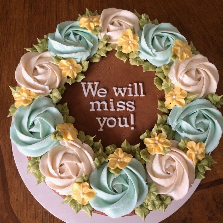 a cake with frosting and flowers on it that says, we will miss you