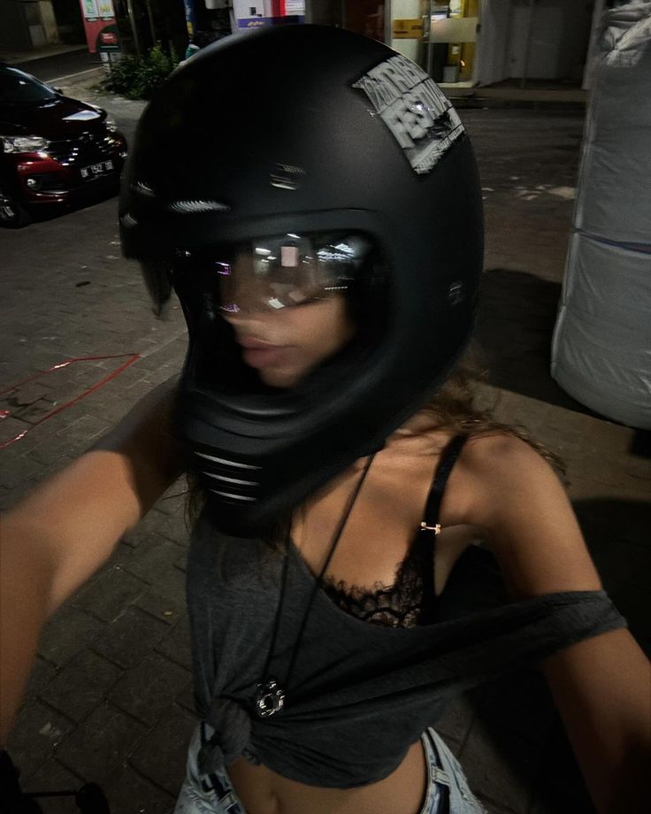 a woman wearing a black helmet and bra top