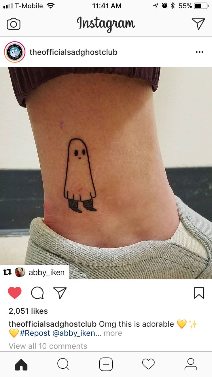 a person with a small ghost tattoo on their ankle and the word instagram written below it