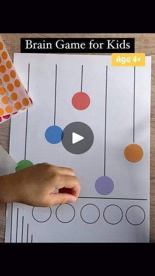 a video demonstrating how to make a brain game for kids with colored circles and dots