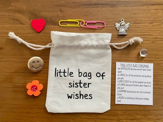 a little bag of sister wishes on a table with buttons and paperclips