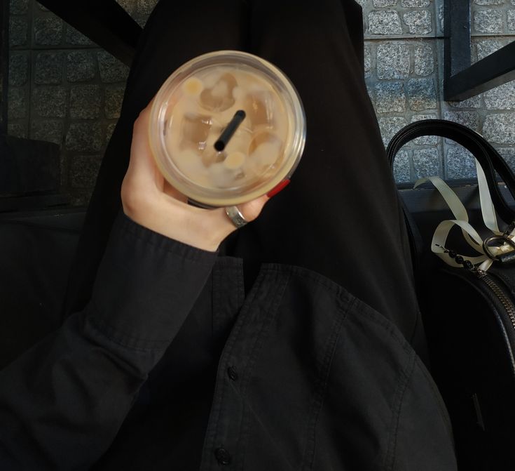 a person holding a plastic cup in their hand