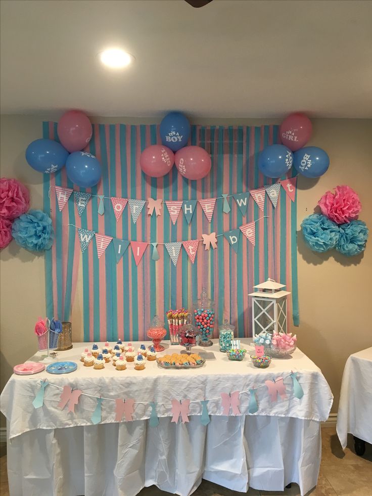 a table topped with lots of desserts and balloons