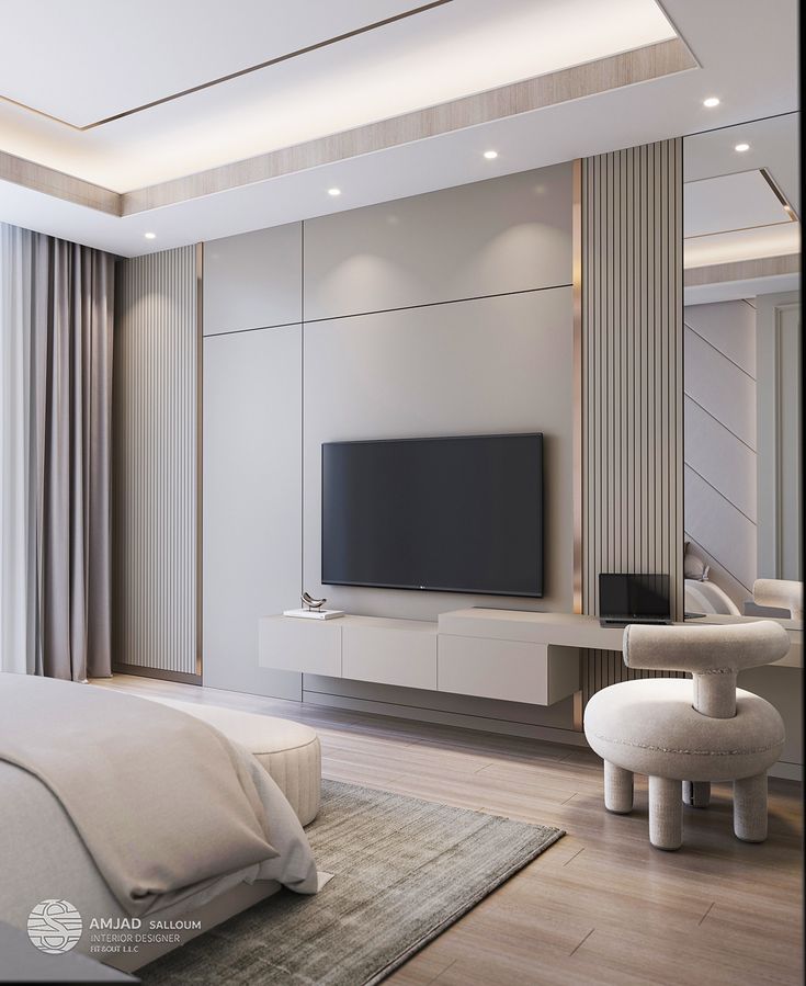 a bedroom with a large flat screen tv on the wall