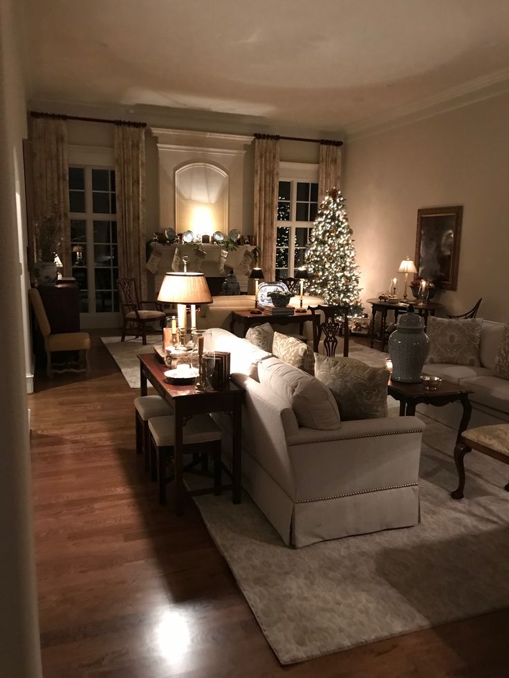 a living room filled with furniture and a christmas tree