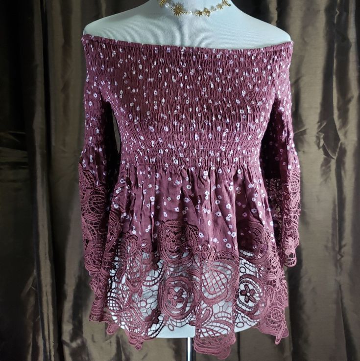 This Ditsy Floral Smocked Off Shoulder Turnic Lace Top. This Easy Fit, Romantic Lace Top Features Crochet Lace In A Classic Floral Lace Pattern. This Off The Shoulders Off The Shoulder Neckline Too! It's So Feminine! The Smocking Is Nice Since It Will Help Keep This Top In Place While Adding Stretchy Comfort! This Top Features With Lace Sleeves, 100% Rayon Crochet 100% Cotton. Junior Tops. Bohemian Fitted Smocked Top For Vacation, Fitted Bohemian Smocked Top For Vacation, Bohemian Long Sleeve Smocked Top With Ruffles, Bohemian Smocked Top With Ruffles For Vacation, Spring Day Out Crochet Top With Ruffles, Bohemian Smocked Top For Vacation, Spring Crochet Top With Ruffles For Day Out, Fitted Bohemian Smocked Top, Spring Bohemian Peasant Top With Smocked Bodice