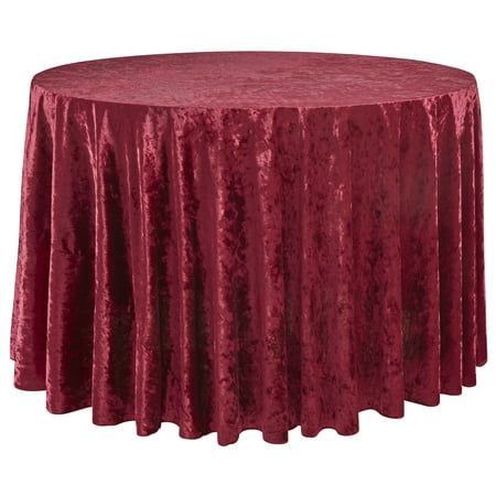 a round table covered in a red crushed velvet cloth with pleated edges and a circular top