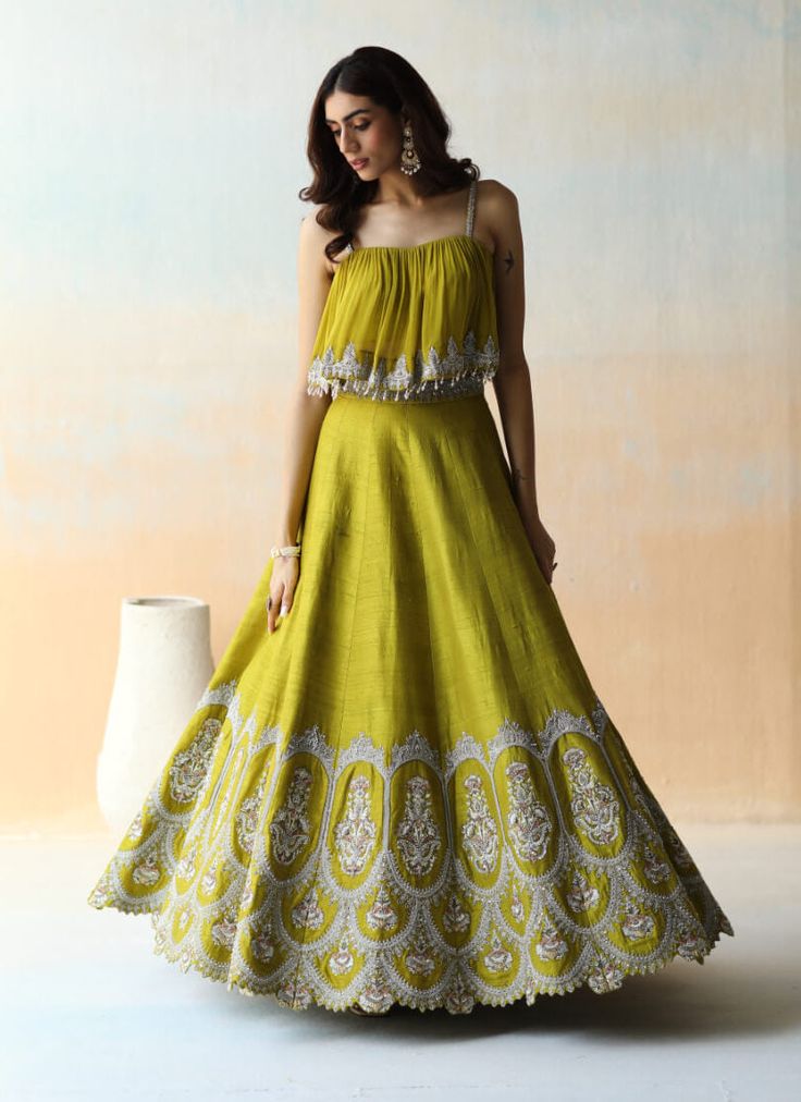 Editor's Note A Lime Green Lehenga Set In Raw Silk Base With Geogette Base Gathered & Embroidered Top Featuring White Floral Thread Embroidery Highlighted With Sequins, Cut Dana And Various Other Embellishments. Color: Green Fabric: Raw Silk & Georgette Care: Dry Clean Only About the Designer Aman Takyar, coveted for bridal couture, handcrafted luxury pret, derives inspiration from the splendid crafts and heritage of India. Lime Green Lehenga, Floral Thread Embroidery, Mehendi Outfit, Raw Silk Lehenga, Trendy Outfits Indian, Mehendi Outfits, Luxury Pret, Lehenga Designs Simple, Green Lehenga