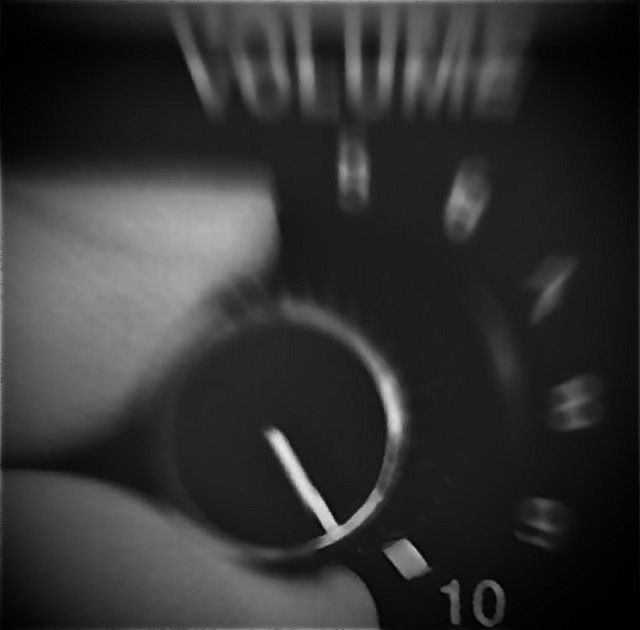 a close up of a person's hand with a watch on their wrist in black and white