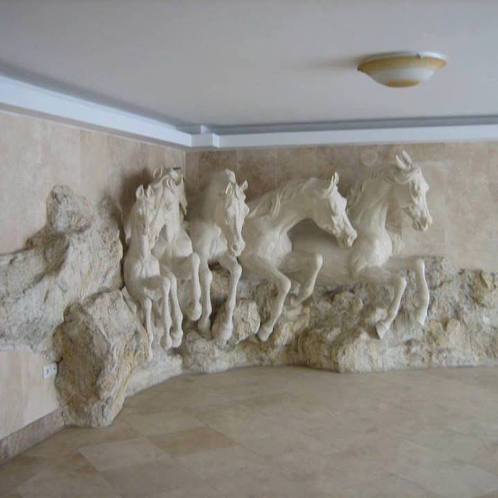 some white horses statues in a room