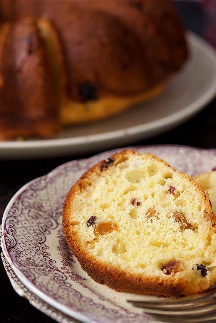 a piece of cake sitting on top of a plate next to a loaf of bread