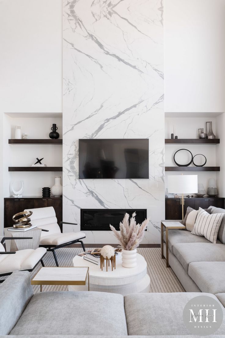 a modern living room with marble walls and white furniture