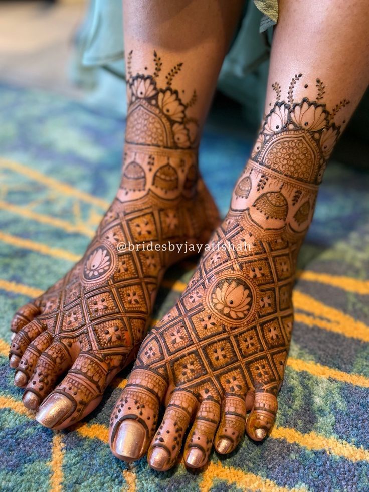 a woman's feet with hennap on it and the bottom part of her legs