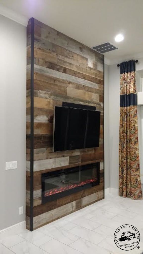 a living room with a tv mounted on the wall and a fire place in front of it