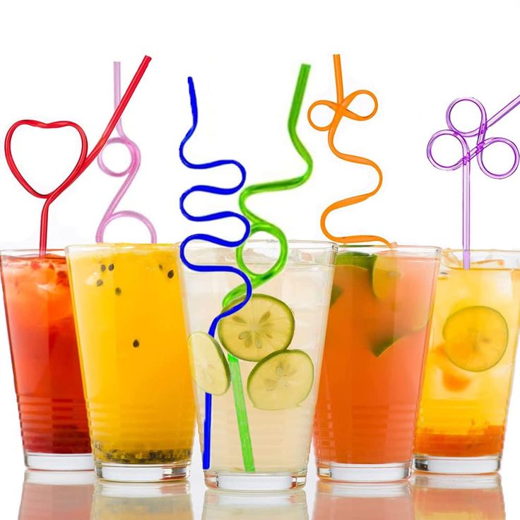 four glasses filled with different types of drinks and straws in each glass are lined up