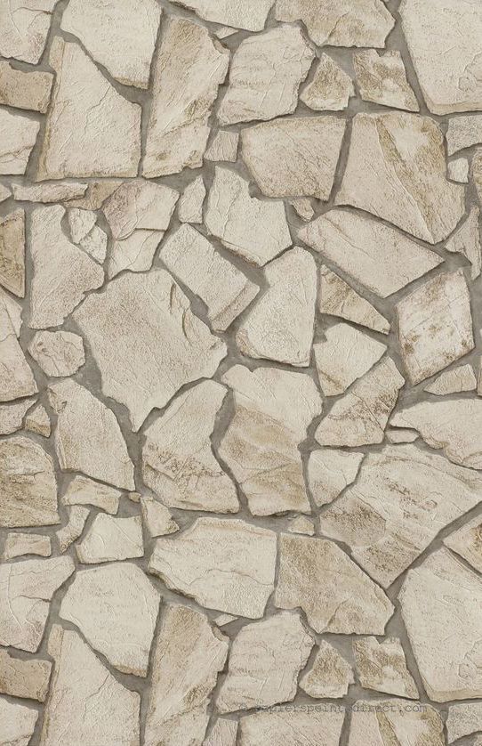 a stone wall that has been made from various types of stones and is beige with white trim