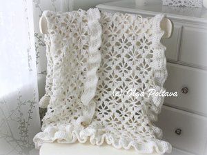 a white crocheted blanket sitting on top of a dresser