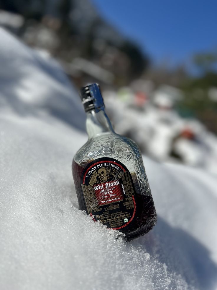 a bottle of alcohol sitting in the snow