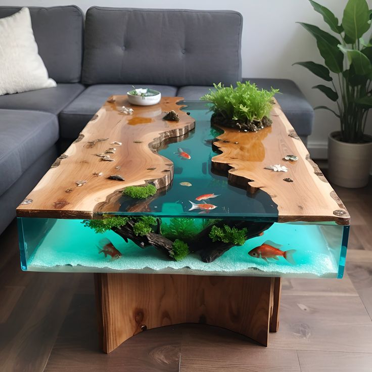 a coffee table with fish and plants on it in the middle of a living room