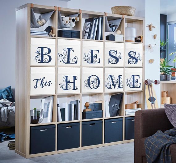 a living room filled with furniture and bookshelves covered in blue letters that spell out the word,'bess this home '