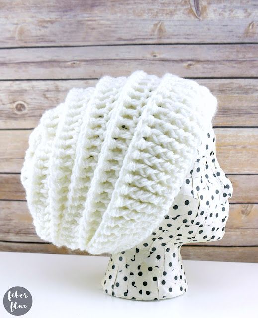 a white knitted hat with black dots on it