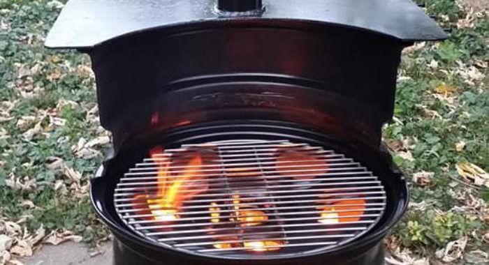 an open charcoal grill with flames burning in it's center and on the outside