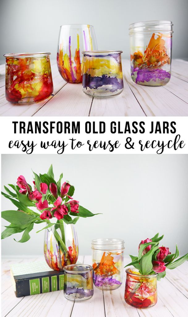 glass jars filled with flowers and plants on top of a white wooden table next to each other