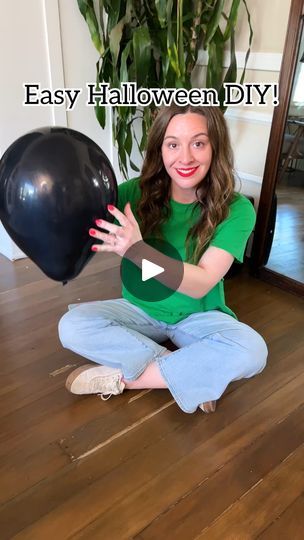 a woman sitting on the floor holding a black balloon in front of her face with text that reads easy halloween diy