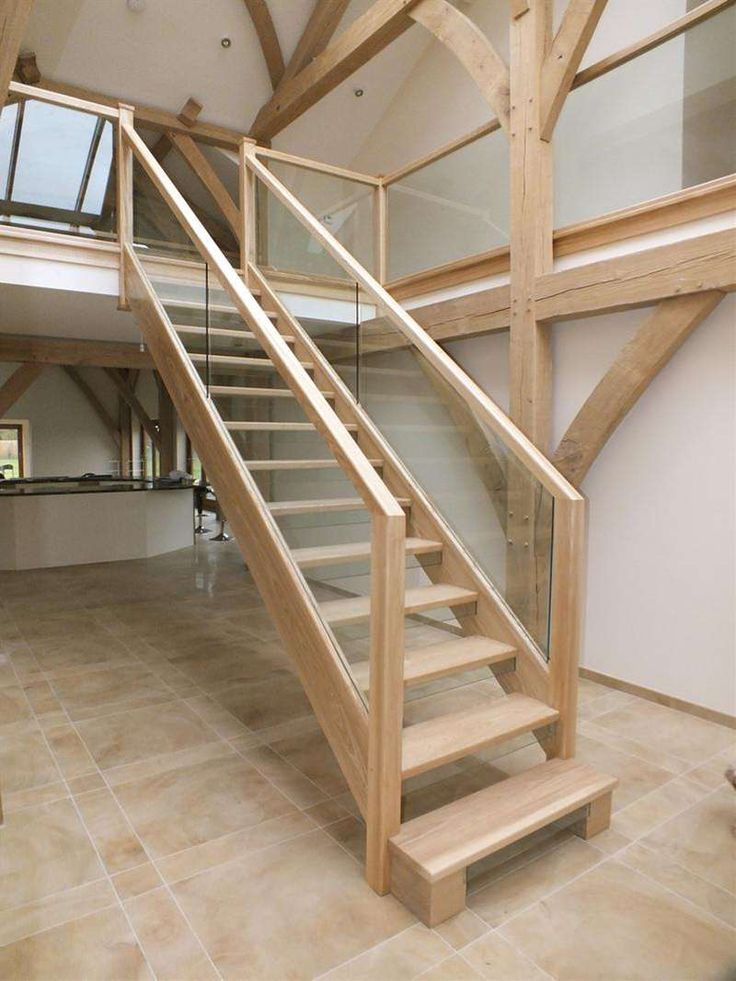 a wooden stair case with glass balconies