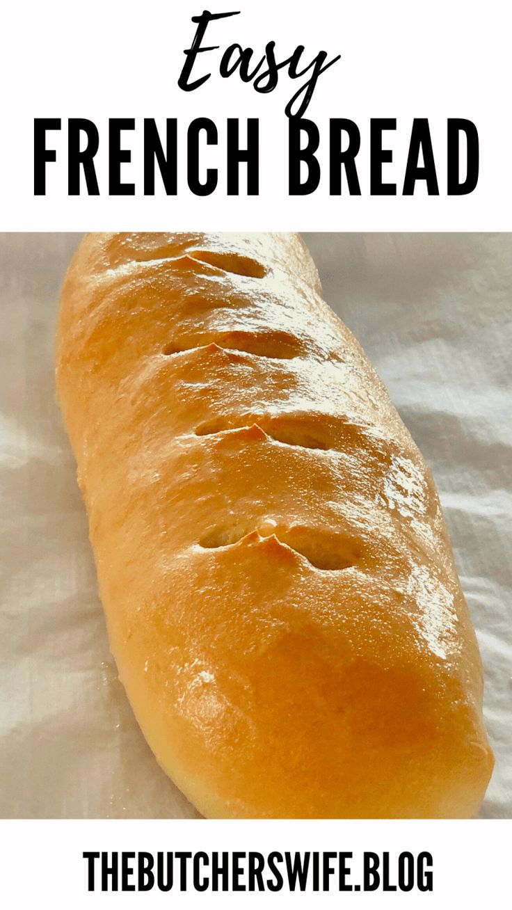 a long loaf of bread sitting on top of a white table cloth with the words easy french bread