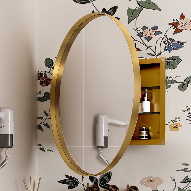 an oval mirror mounted to the side of a wall next to a hair dryer