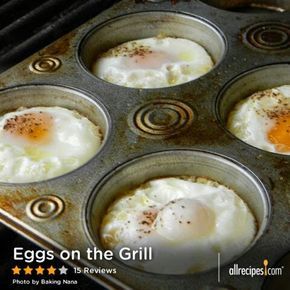 four eggs in a muffin tin on the stove