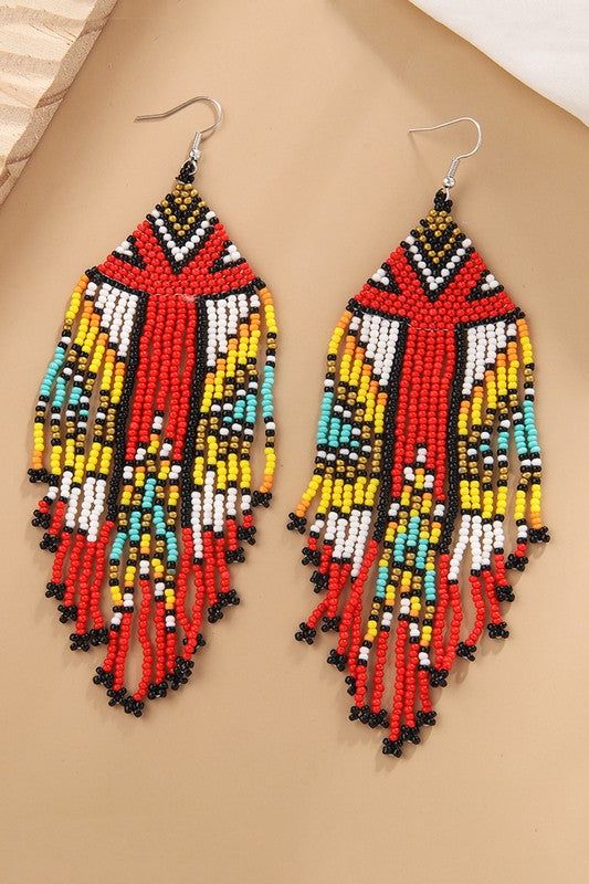 Introducing the Tribe Earrings! With multi-colored beads, these unique and bold earrings will set you apart from the rest. Suitable for the modern-day tribalista, these earrings are a guaranteed conversation starter! Show off your bohemian vibes and don't forget to take a selfie! Bohemian Beaded Dangle Earrings, Bohemian Beaded Dangling Earrings, Colorful Beaded Earrings For Summer, Colorful Beaded Summer Earrings, Beaded Bohemian Chandelier Earrings, Bohemian Beaded Chandelier Earrings, Summer Colorful Beaded Earrings, Unique Multicolor Large Beads Earrings, Bohemian Earrings With Colorful Beads